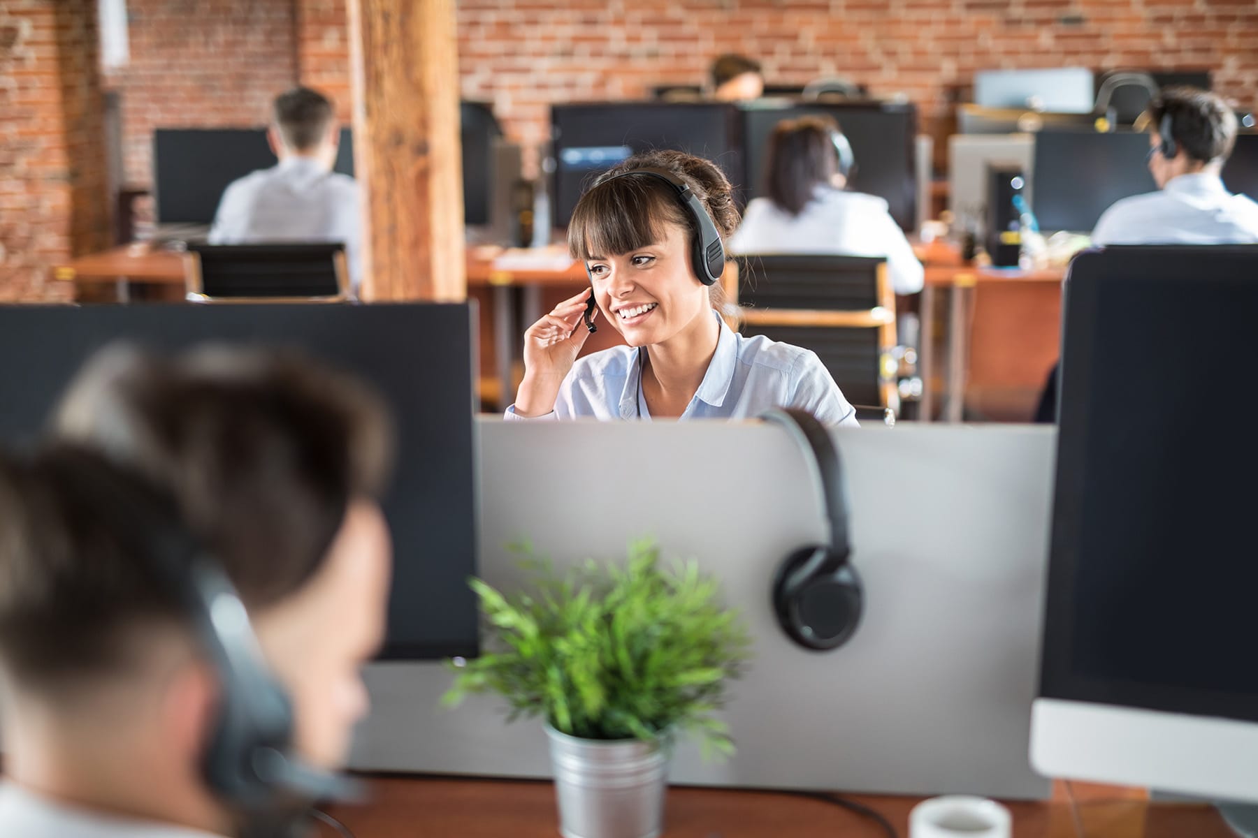 person in an office setting talking on a headset