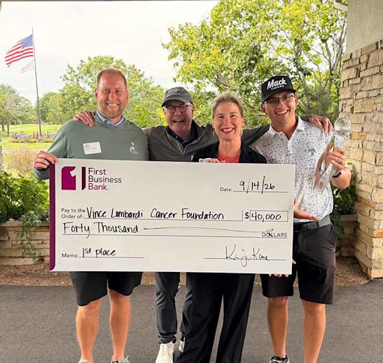Jared Pfeffer and Rick Bergstrom holding a large check for $40,000 for Vince Lombardi Cancer Foundation