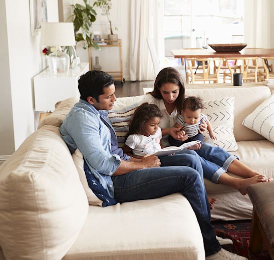 a family sitting on a couch