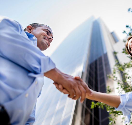 people shaking hands outside