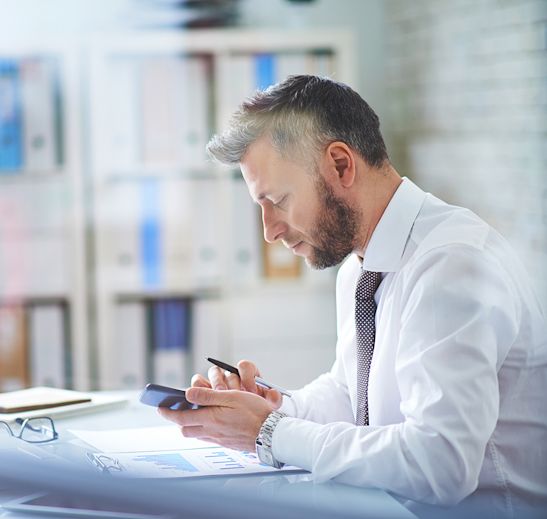 man at a desk on a phone