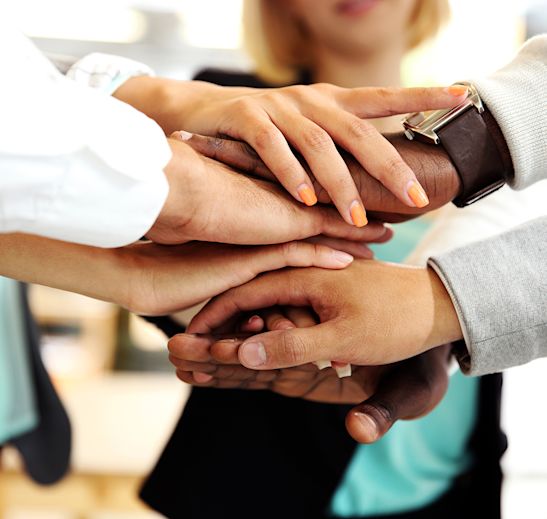 Hands stacked in a team huddle