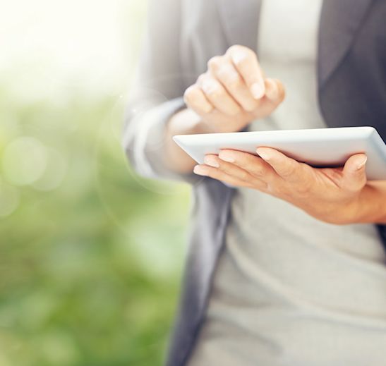 woman with an ipad outside