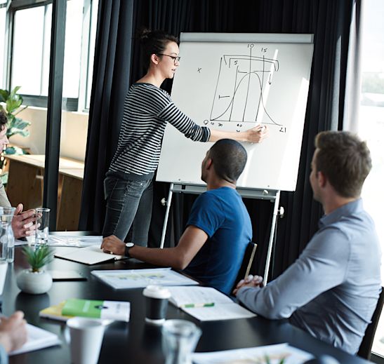 a woman presenting to a team