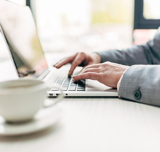 woman typing laptop to assist with commercial lending inquiry