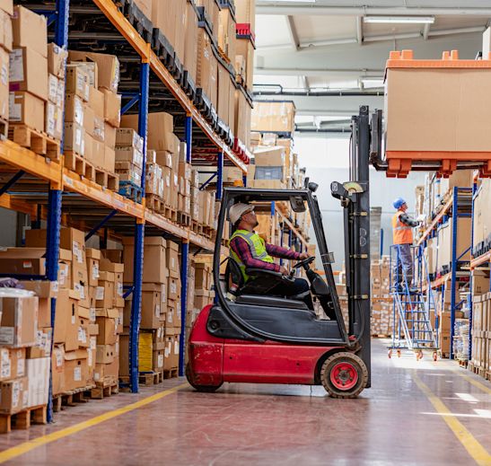 forklift driving working in a warehouse