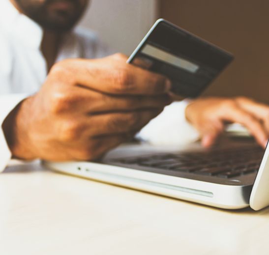 a person entering credit card information into a computer