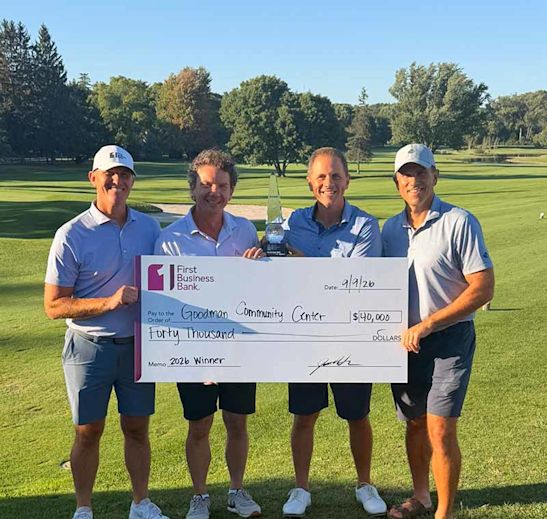 Chris Ehlers and Adam Nonn holding large check for $40,000 for Goodman Community Center