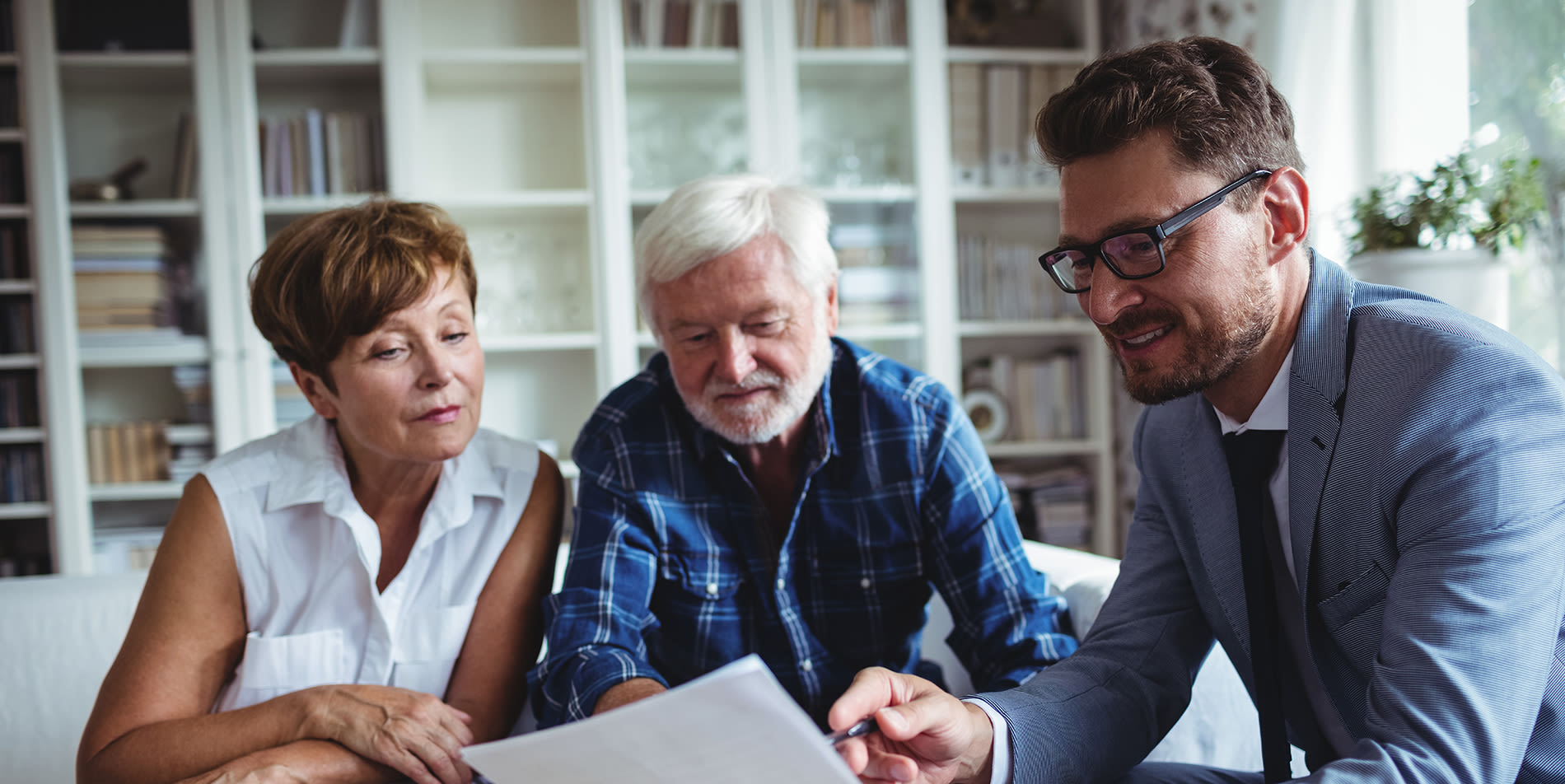 Senior couple going over documents with a financial planner