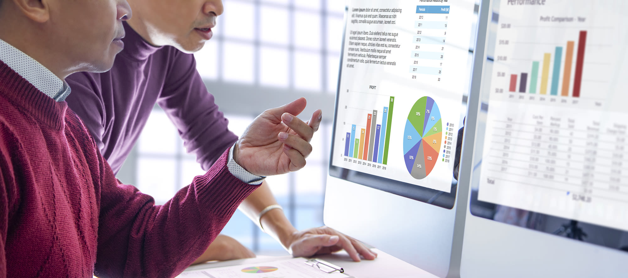 People looking at graphs on a computer for a contingency funding plan