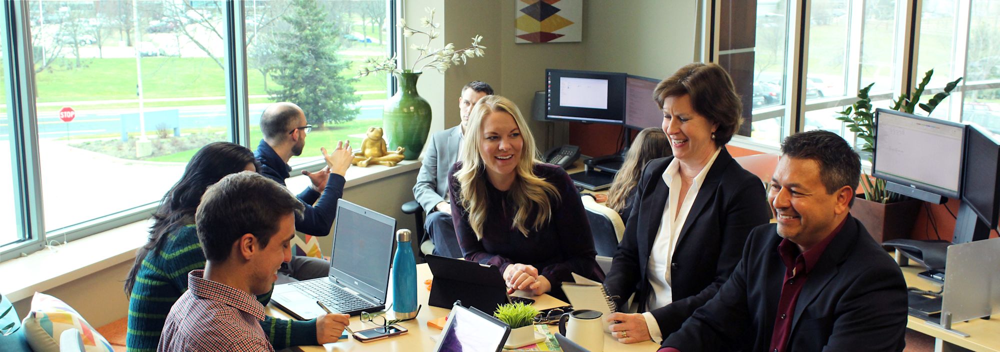 a group of coworkers sitting around a table