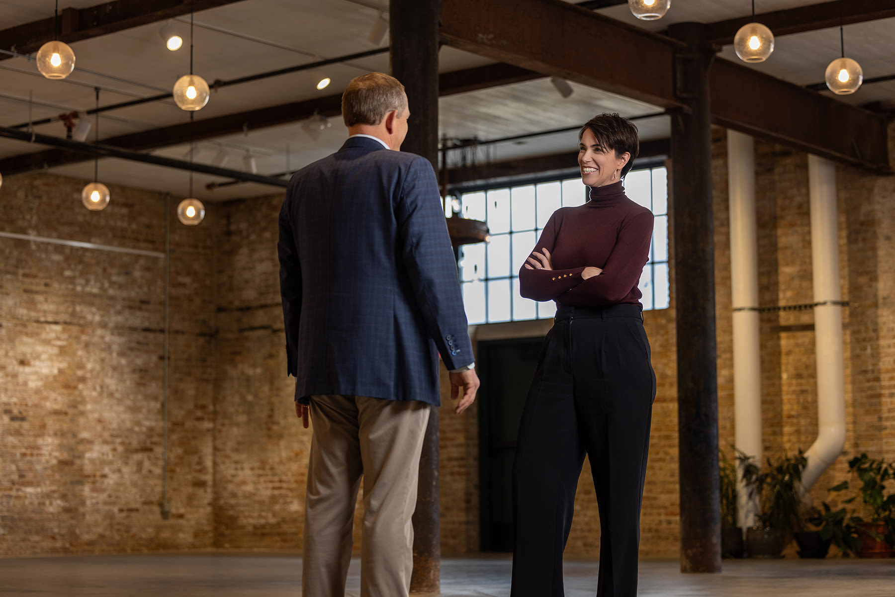 Niamh Kristufek standing in an open indoor space talking with someone