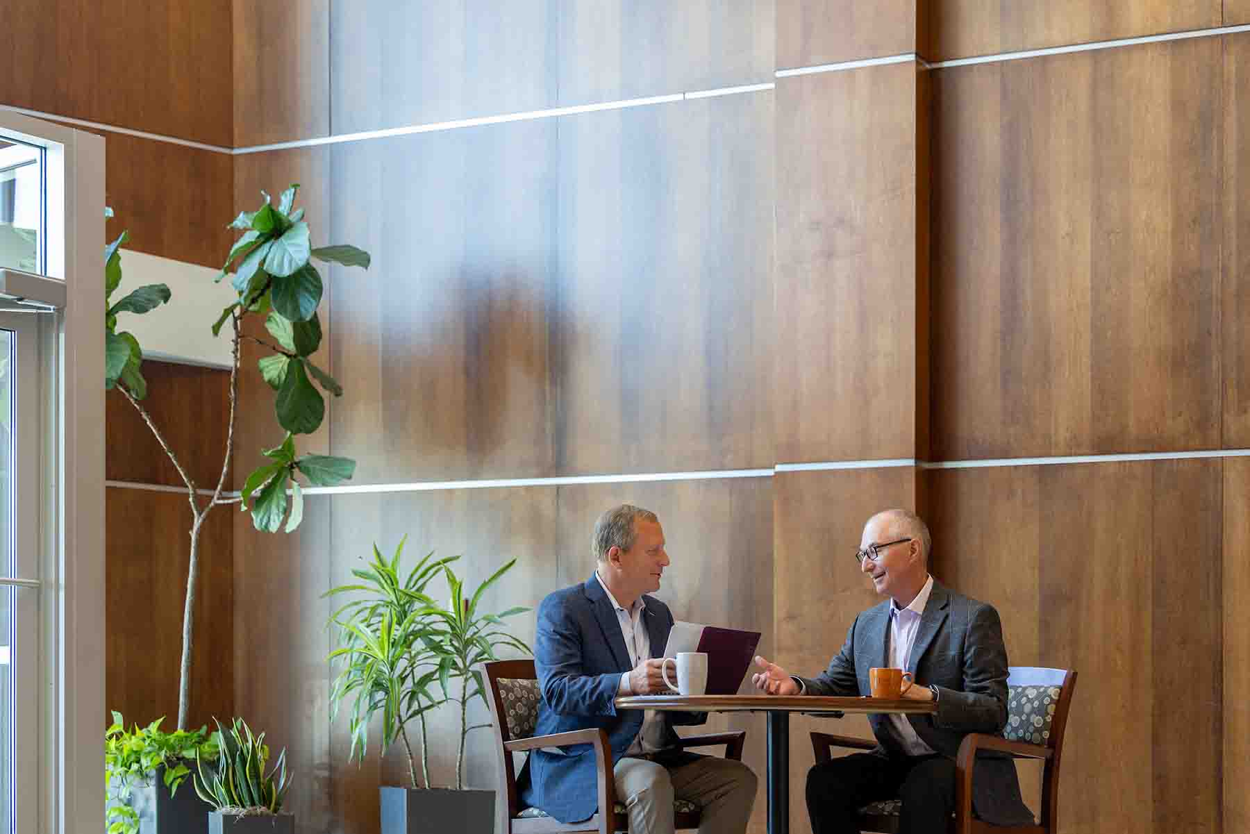 Corey Chambas and Dave Seiler having a meeting at table