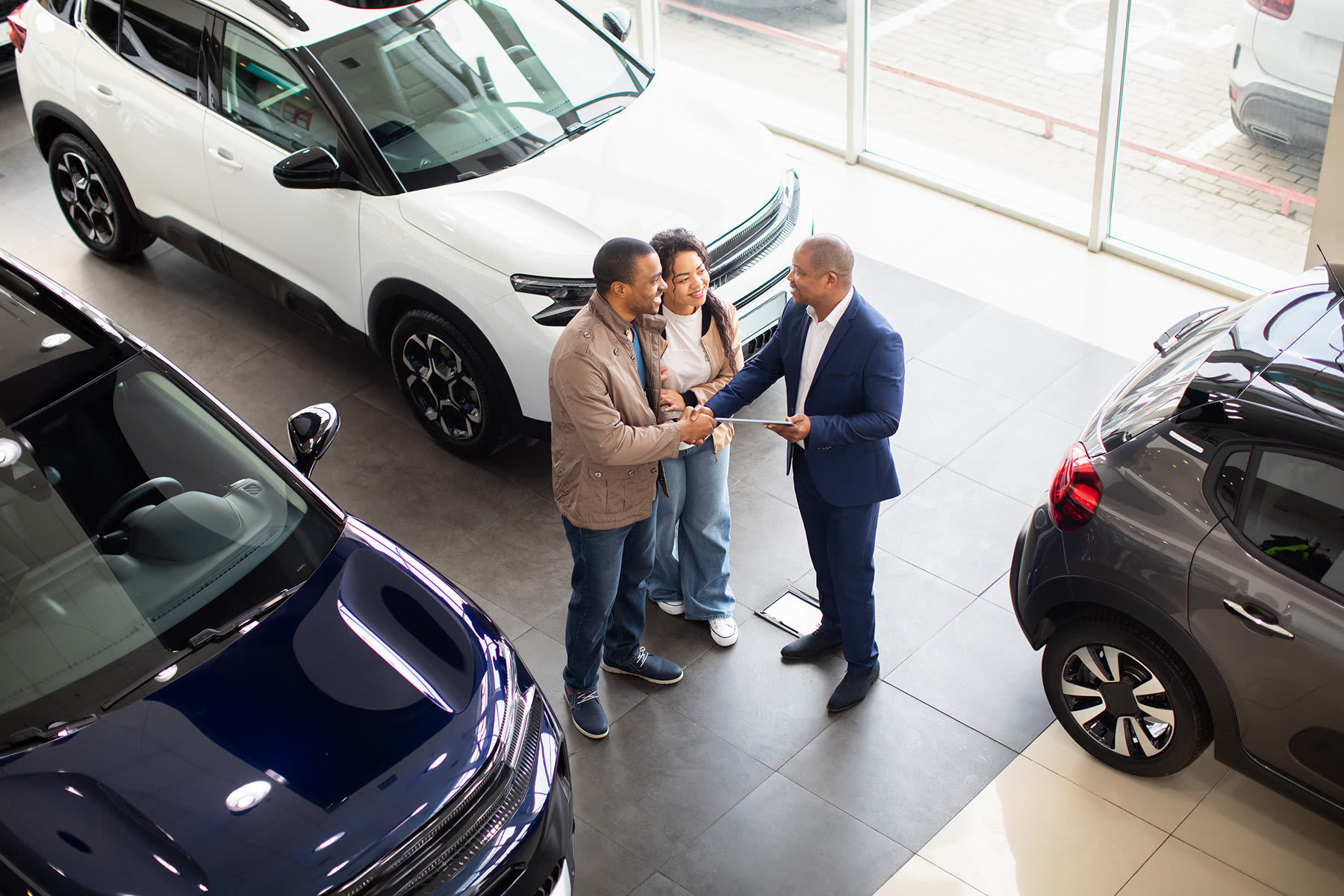 a couple purchasing a vehicle in a dealership