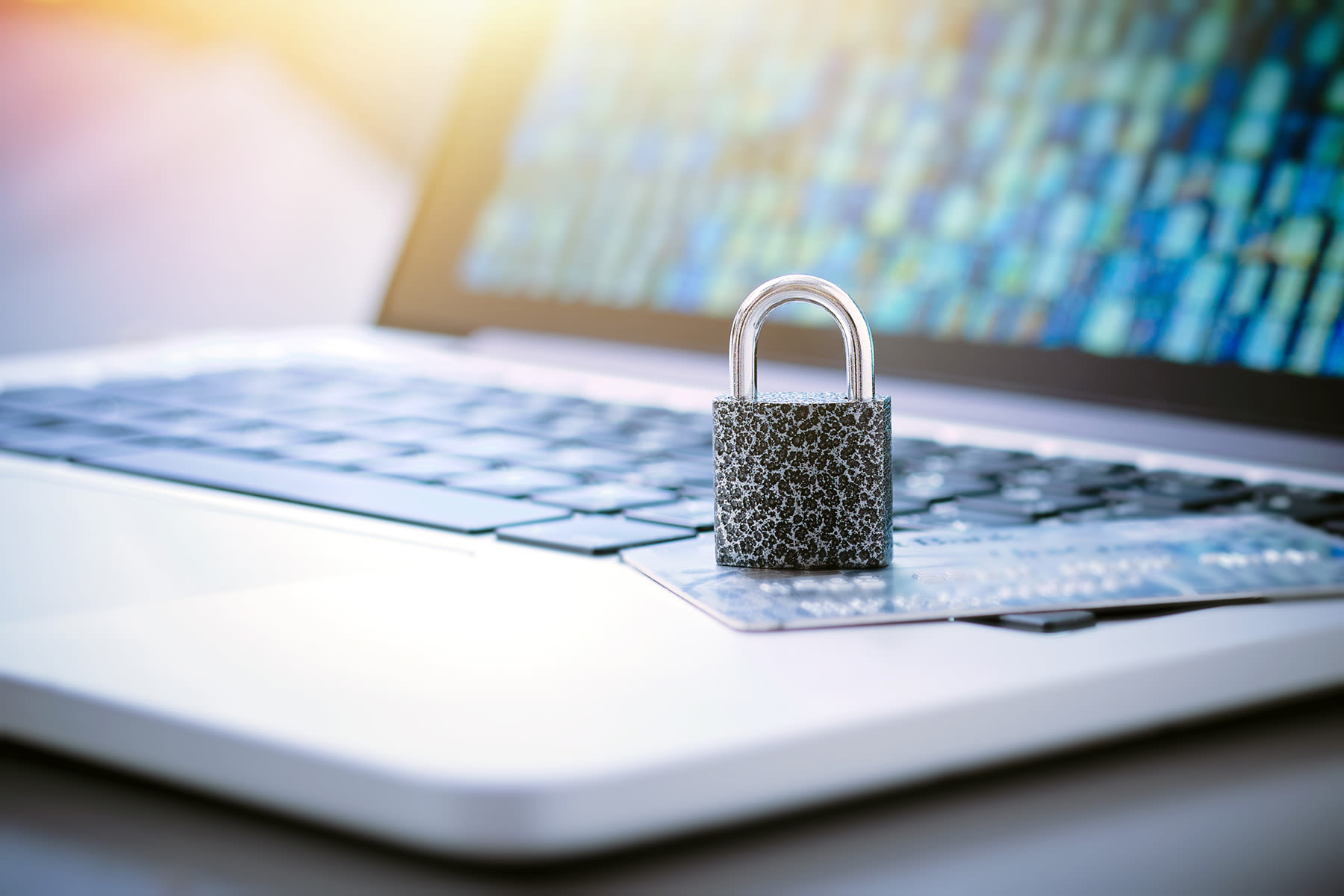A silver padlock on a laptop keyboard