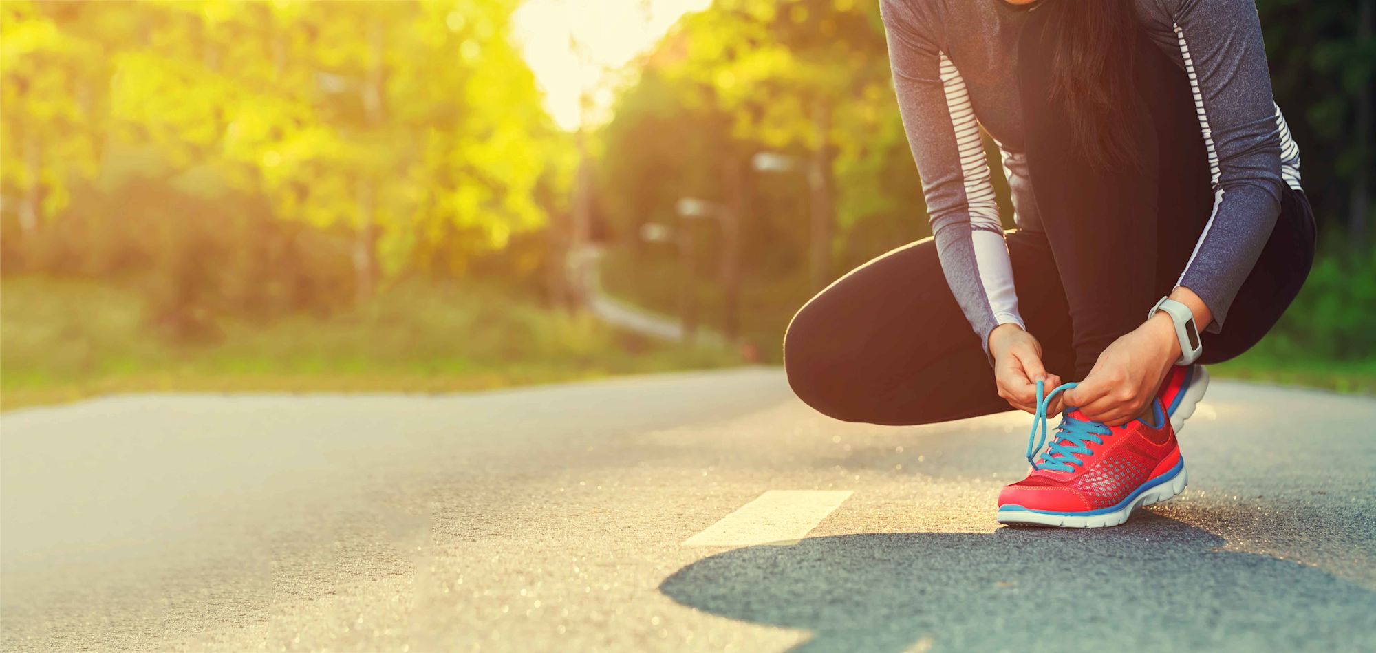 person tying their running shoes
