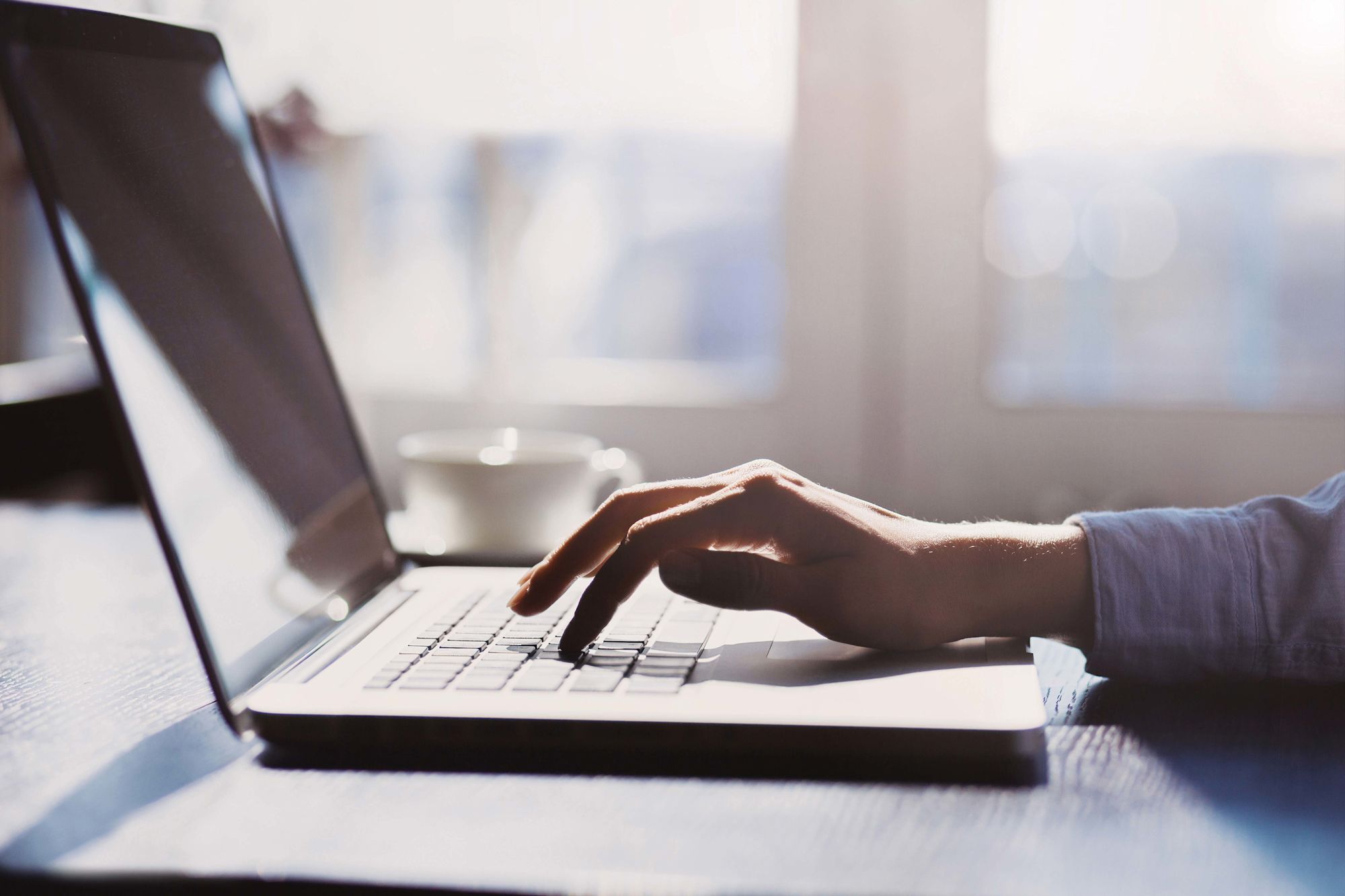 person typing on laptop