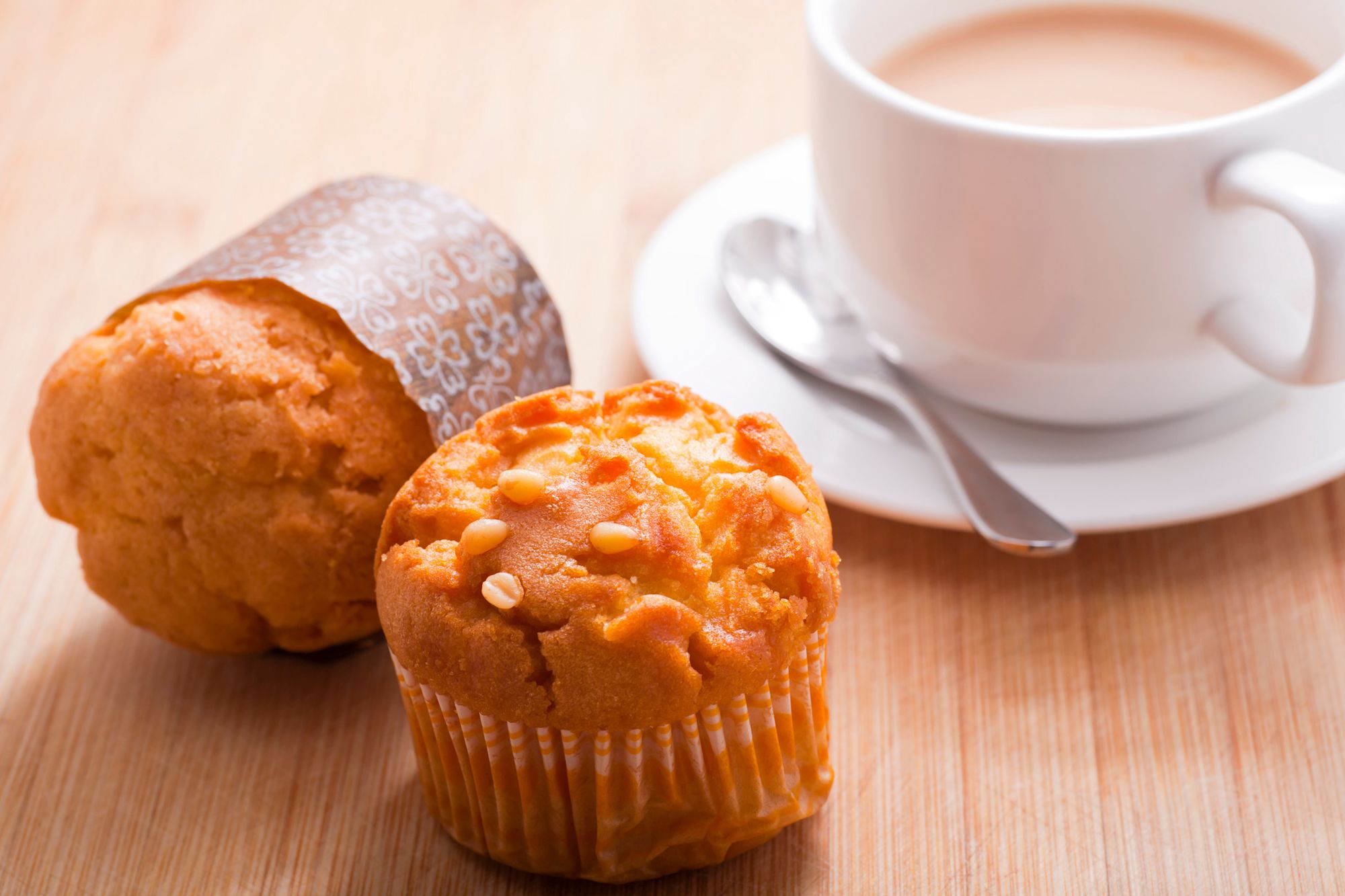 two muffins and a coffee on a table