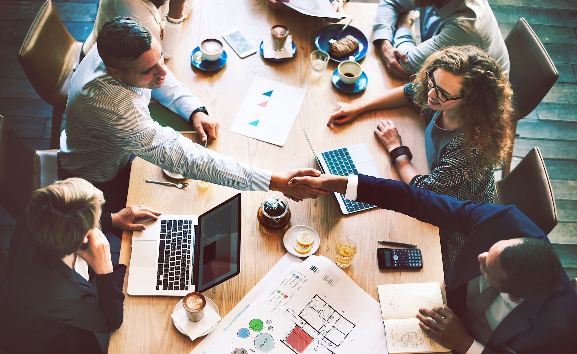 group of coworkers collaborating at a large desk