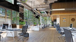 Vacant open office with desks and chairs.