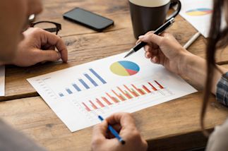 two people looking at a chart