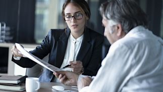 two business people looking over documents