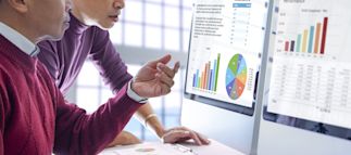 People looking at graphs on a computer for a contingency funding plan