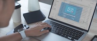 Person on laptop receiving a warning message on their laptop screen.