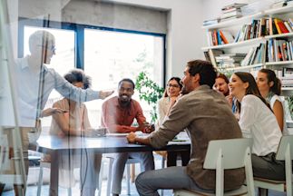 someone presenting to a group of individuals around a table