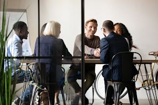 a group of professionals sitting together and discussing something