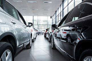 cars lined up inside a car dealership