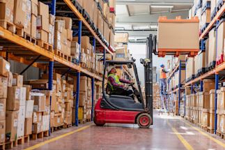 forklift driving working in a warehouse