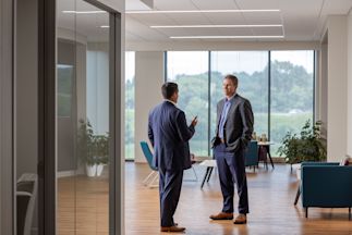 Jim Hartlieb talking with someone in an office room