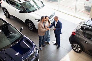 a couple purchasing a vehicle in a dealership