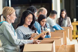 a group of volunteers sorting through boxes