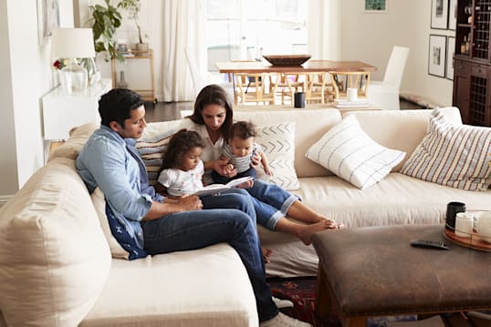 a family sitting on a couch