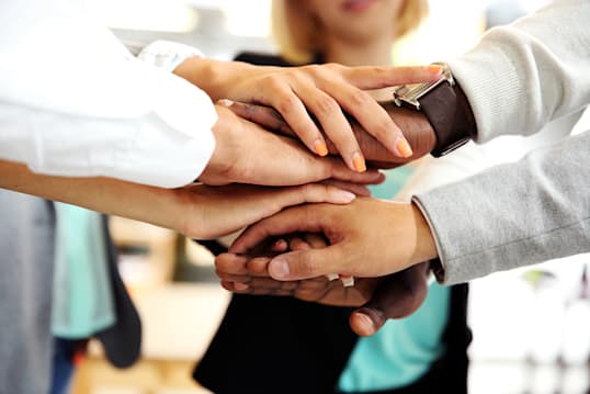 Hands stacked in a team huddle