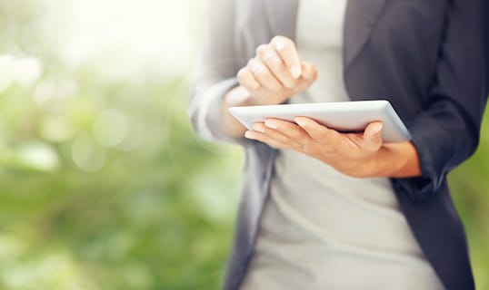 woman with an ipad outside