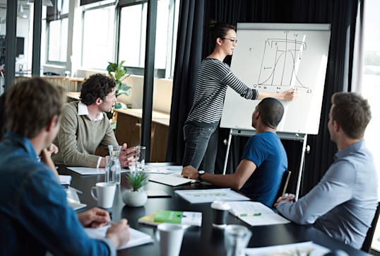 a woman presenting to a team