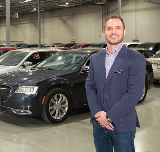 Person standing in front of cars