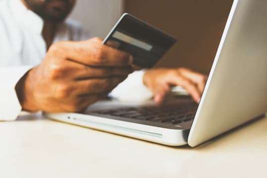 a person entering credit card information into a computer