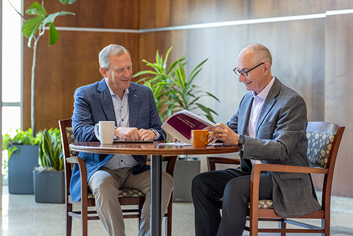 Dave Seiler and Corey Chambas sitting at a table