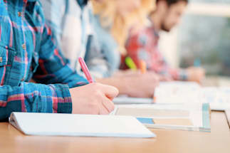 People writing in a book