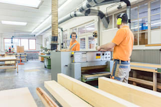 two employees working in a woodshop