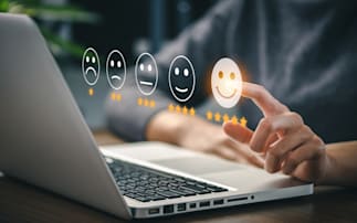 person selecting satisfied icon on computer