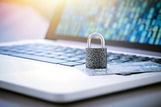 A silver padlock on a laptop keyboard