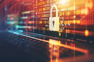 A close-up image of a laptop keyboard with an overlay of digital binary code in red and blue hues, highlighting a padlock symbol in the center, representing cybersecurity and data protection concepts.